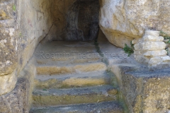 Rock cut vomitorium and stairs on the east side of the theater.