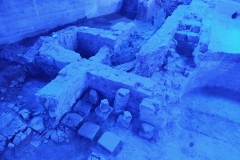 Hypocaust remnants in the tepidarium and adjacent water channels in the baths.